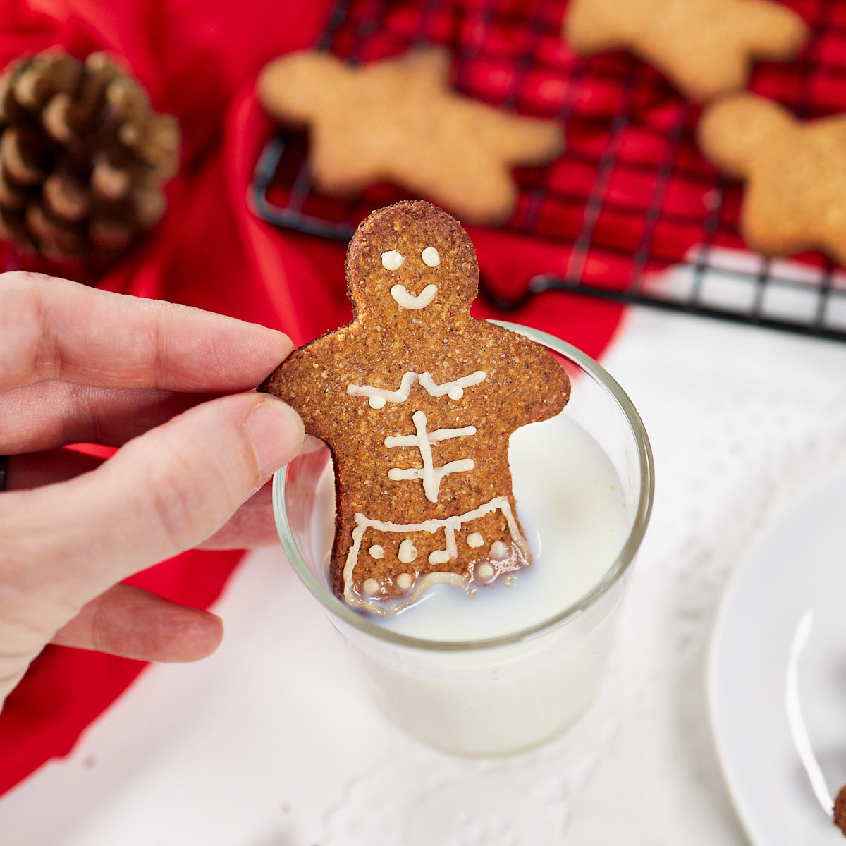 Gingerbread man chilling in a glass of milk.
