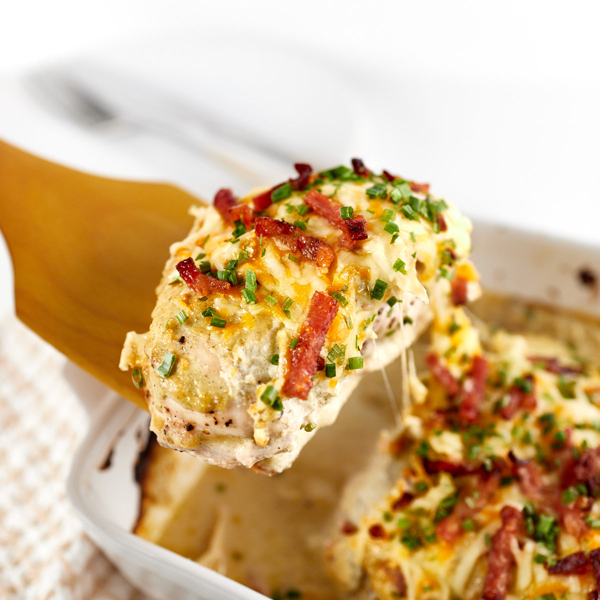 Chicken breast topped with crack dip, melted cheese and bacon.