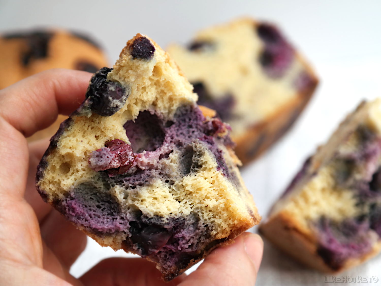 Halved blueberry muffin with beautiful fluffly crumb and lots of blueberries filling.