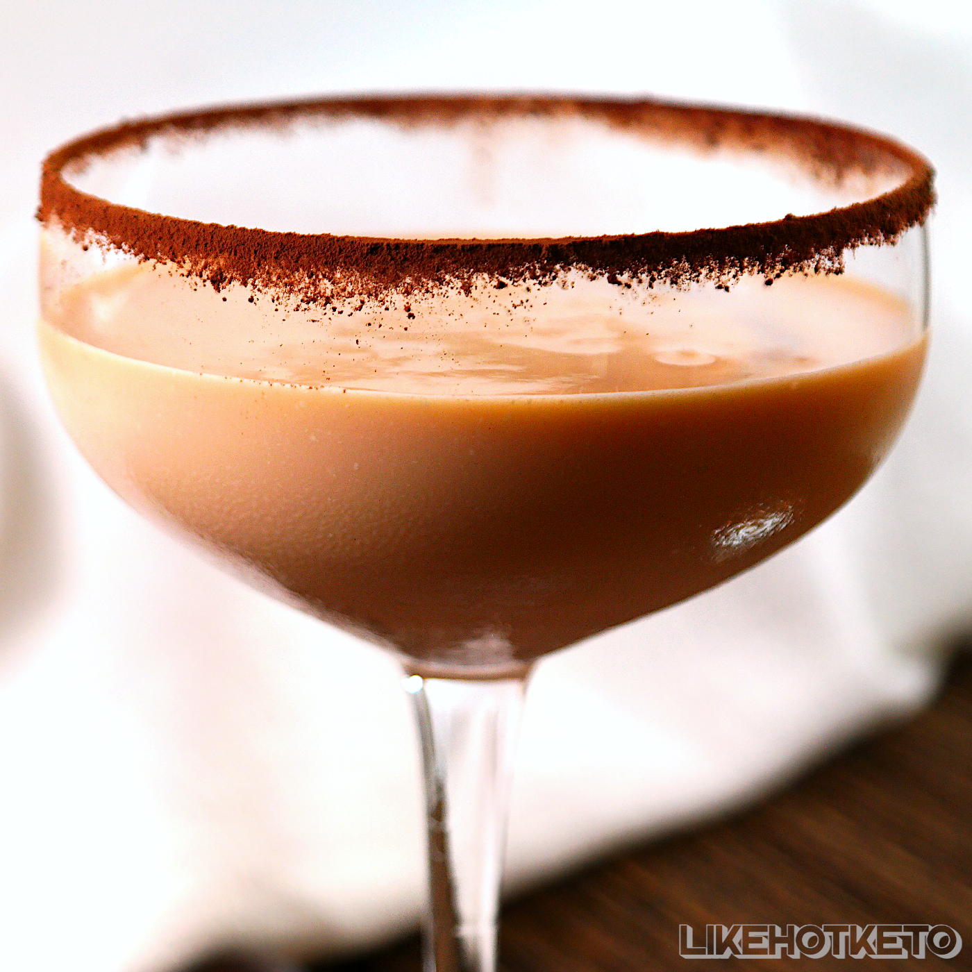 Keto classic Brandy Alexander cocktail in a glass rimmed with cocoa powder.