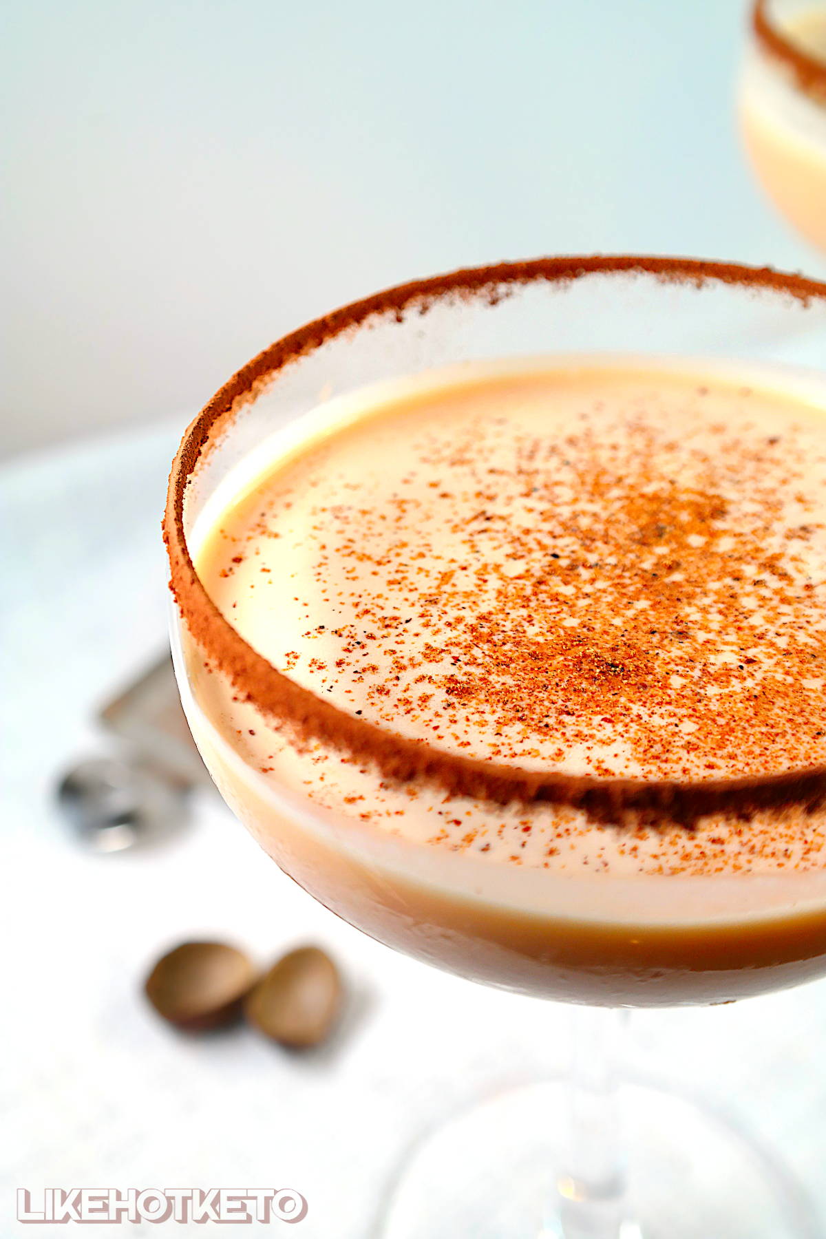 Sugar-free Brandy Alexander cocktail topped with fresh nutmeg in chocolate rimmed glass.