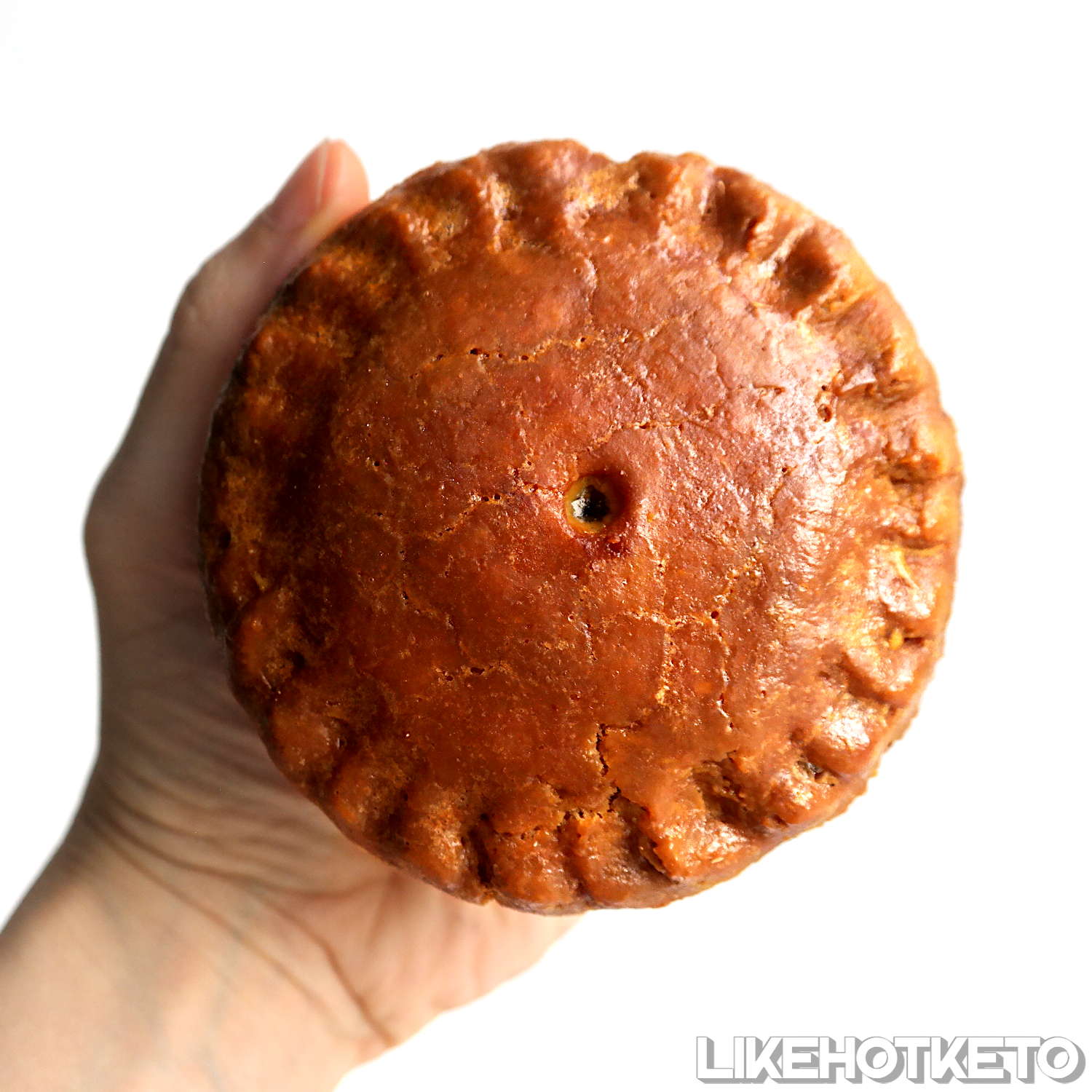 Keto and gluten-free traditional British pork pie with a golden crust.