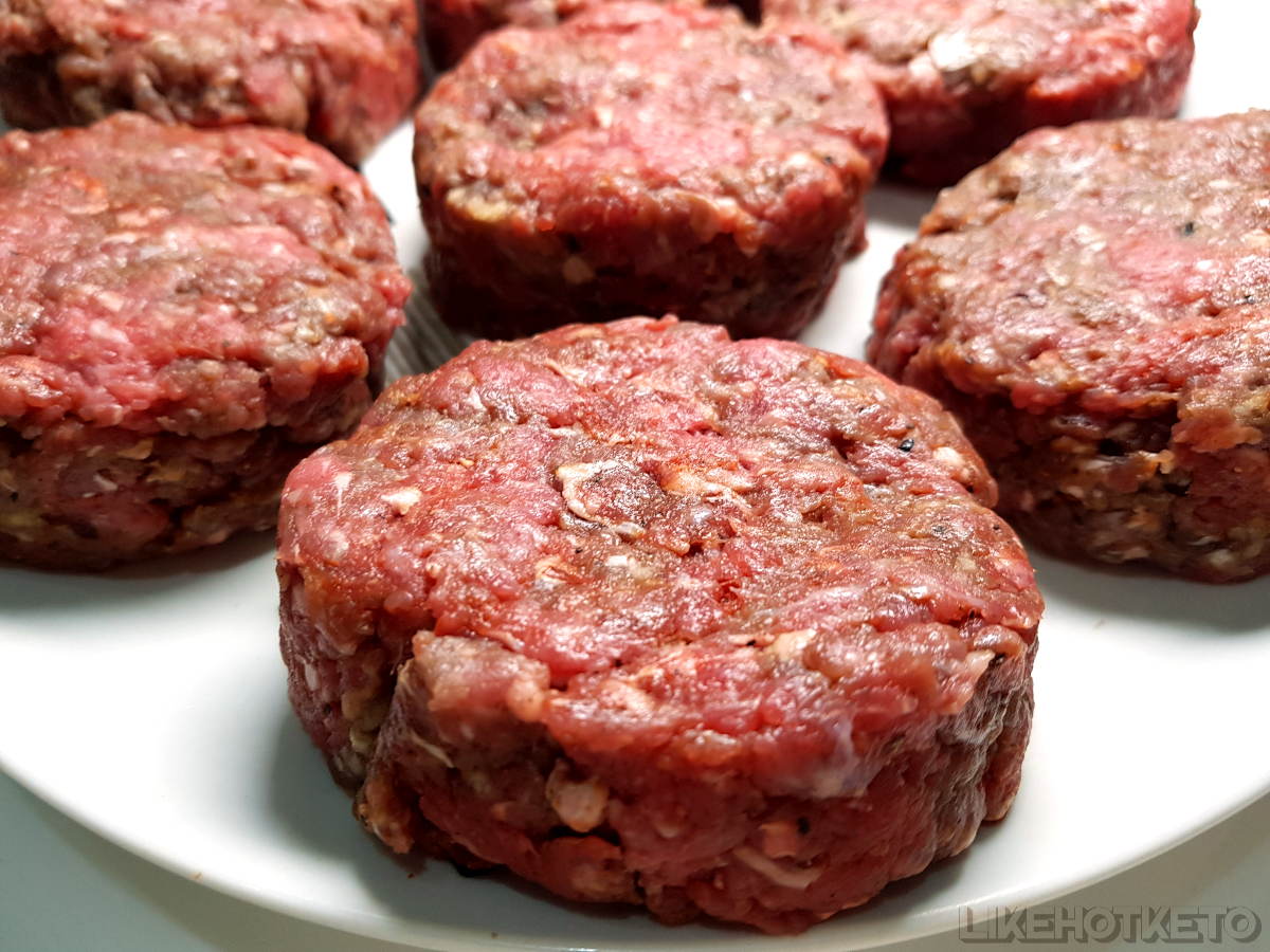 Raw ground beef shaped into stuffed cheeseburgers, ready to air fry.