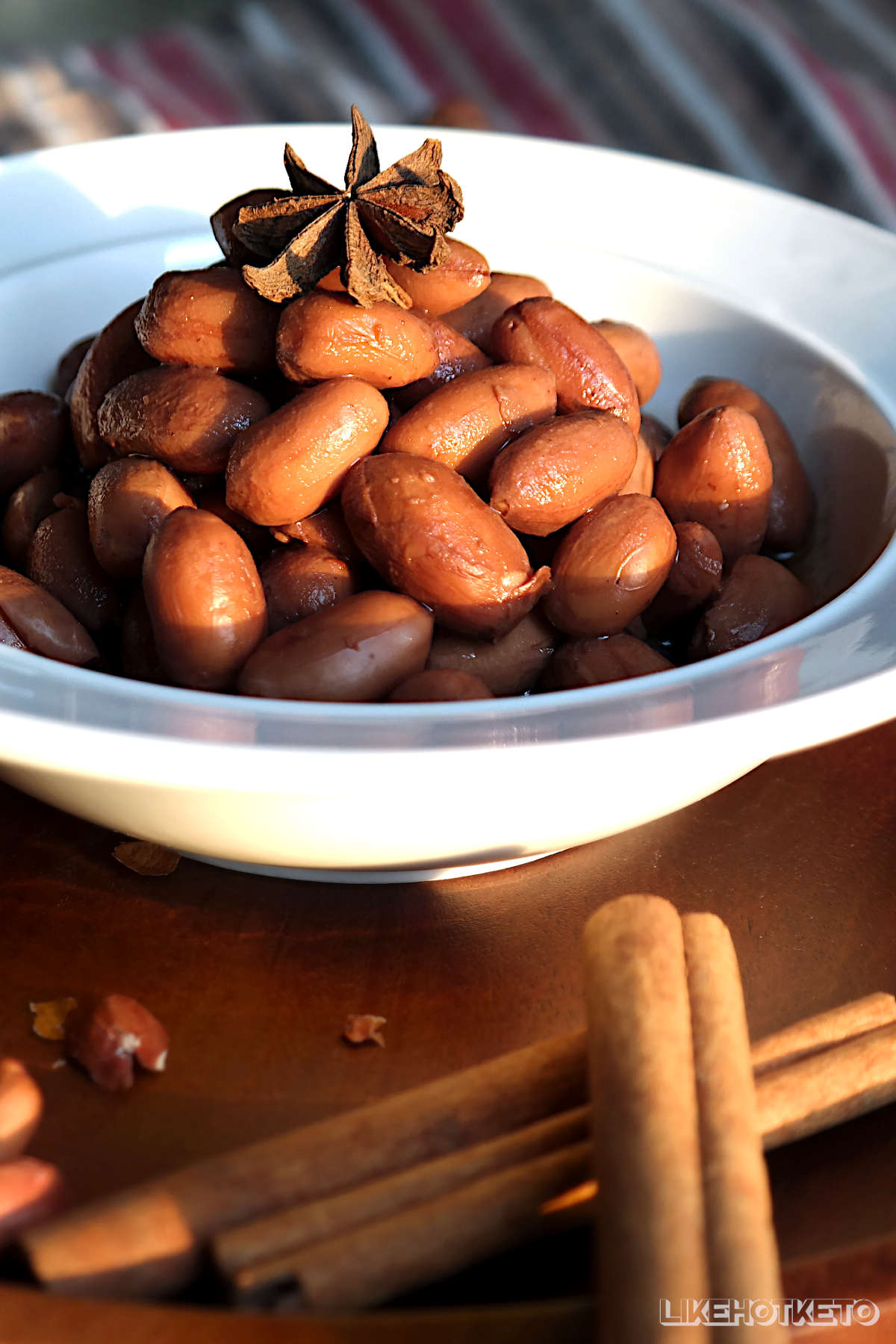 Bowl of Chinese boiled peanuts with star anise and cinnamon sticks.