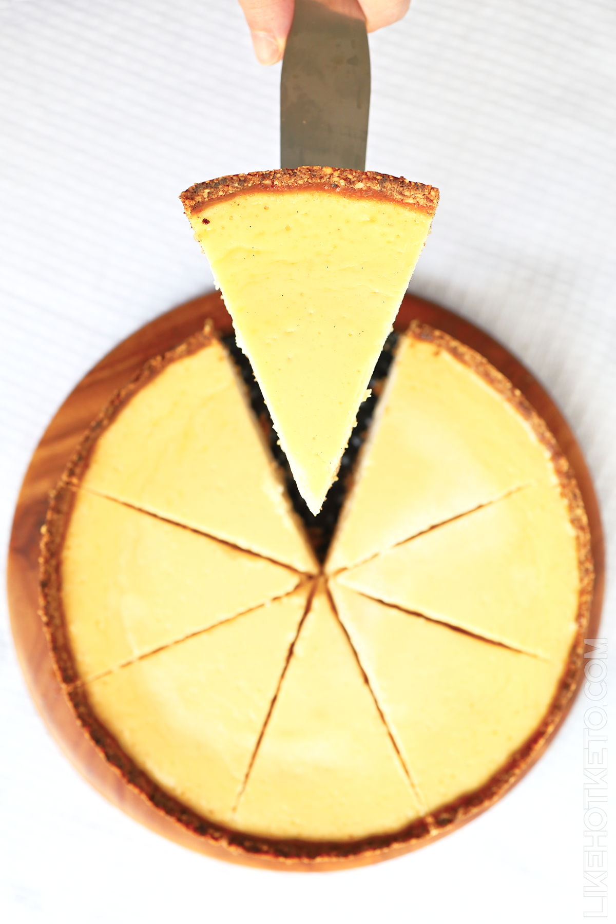 Keto classic vanilla cheesecake just sliced, viewed from the top.