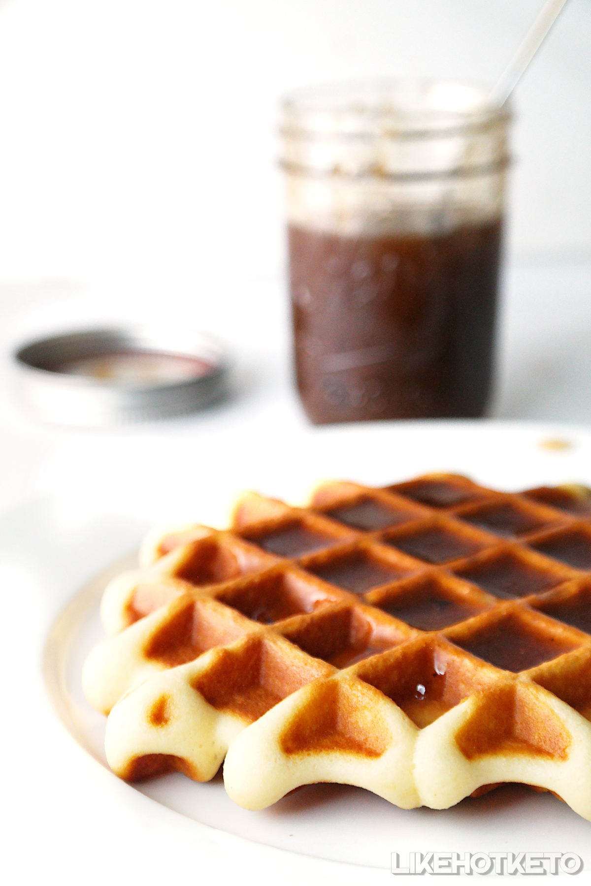 A big keto waffle topped with sugar-free maple syrup.
