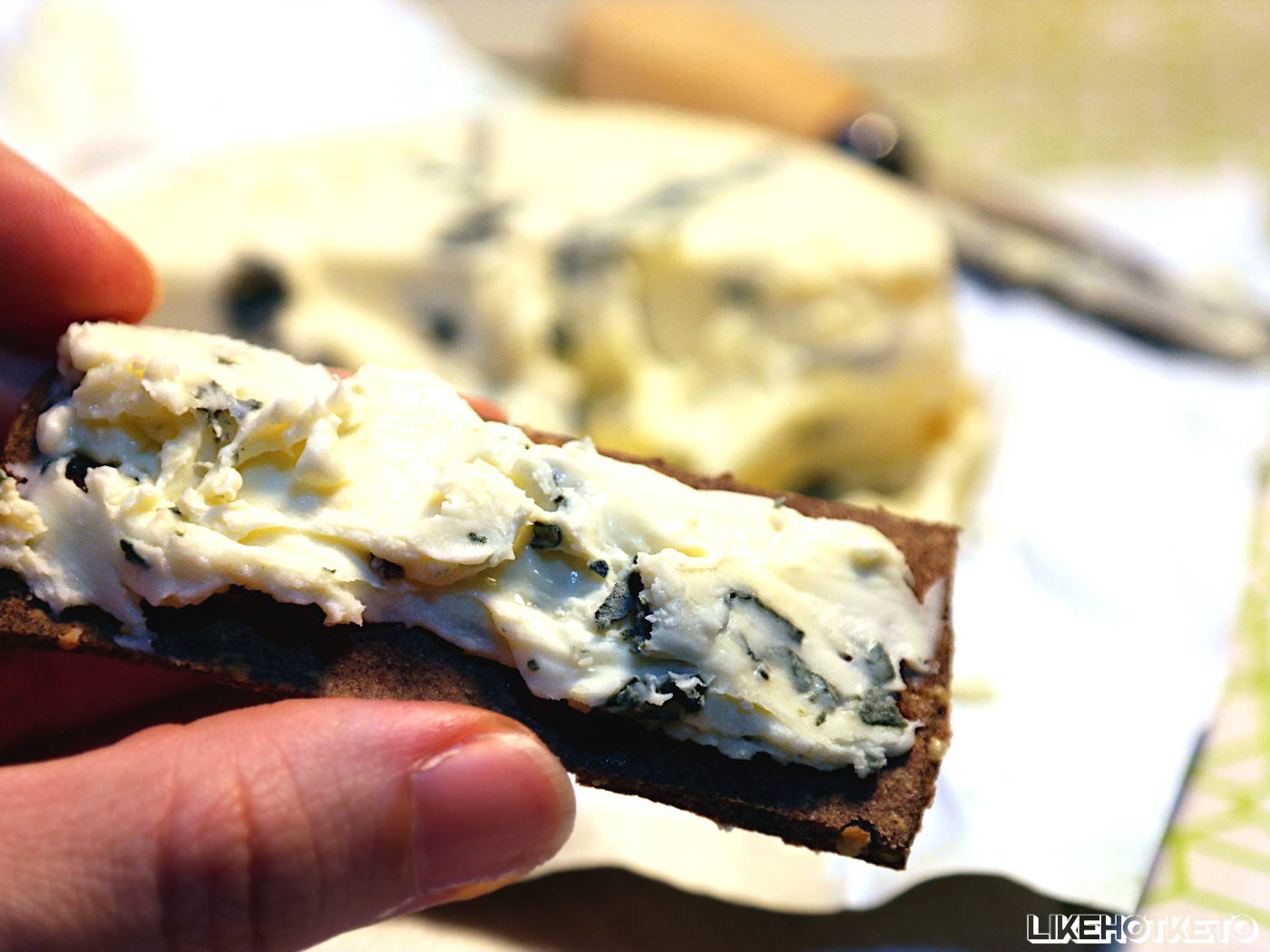 Keto and gluten-free thin cracker topped with soft blue cheese.