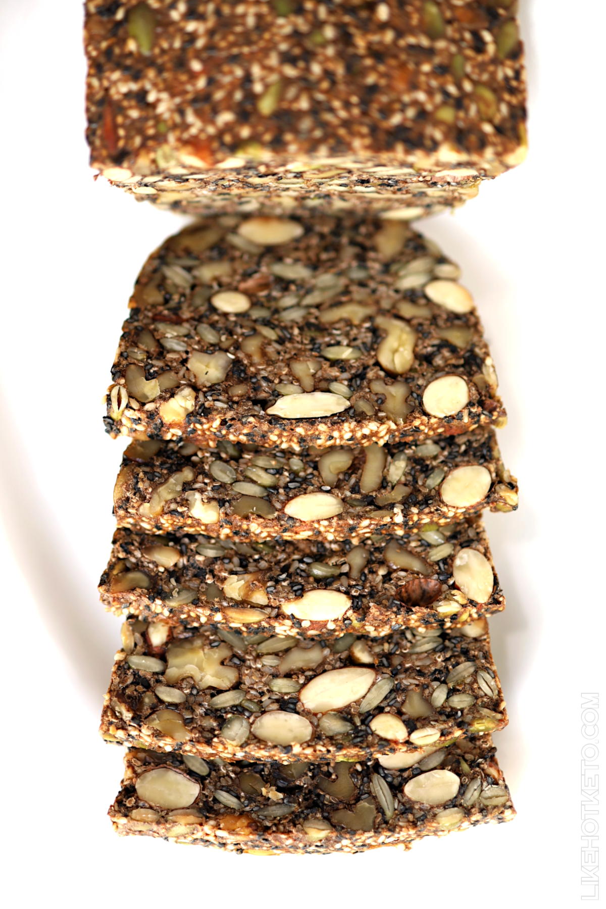 Sliced loaf of gluten-free nut and seed bread.