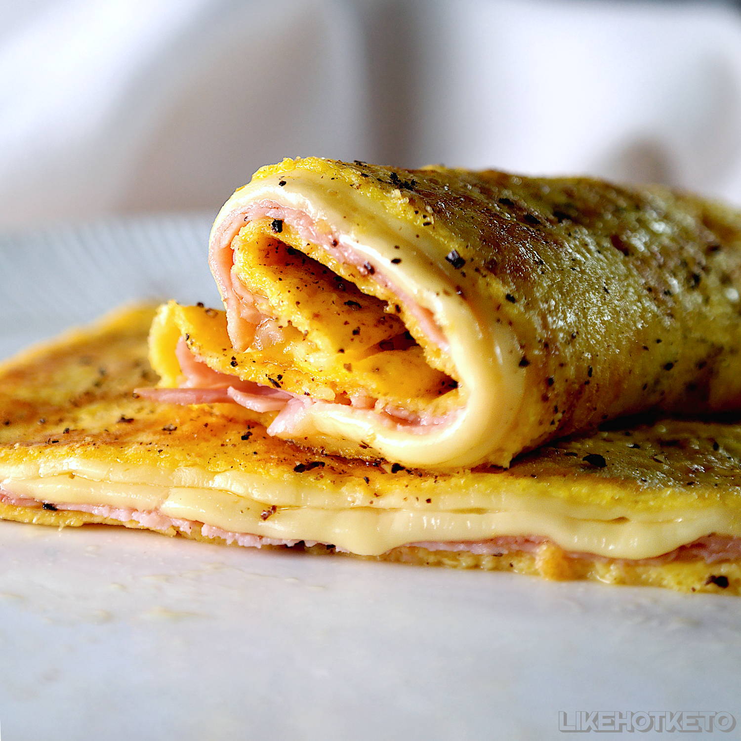 Keto crêpe rolled with ham and cheese.