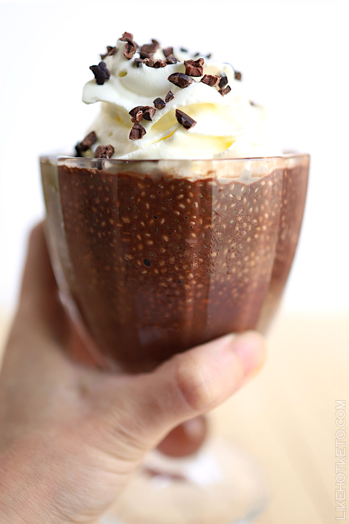 Chocolate chia pudding with whey topped with cream and cacao nibs.