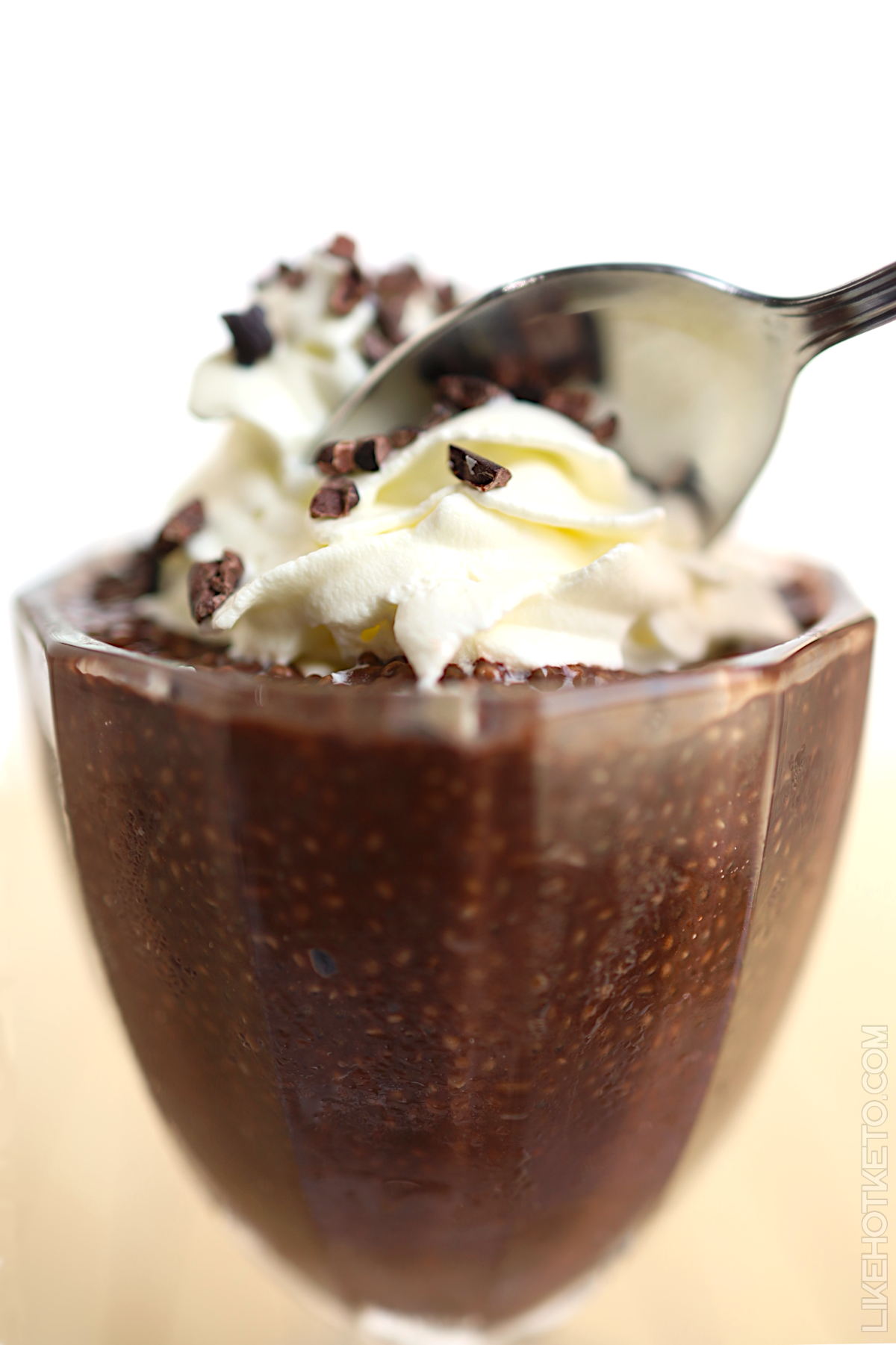 Chocolate protein pudding with whey topped with whipped cream and cacao nibs.