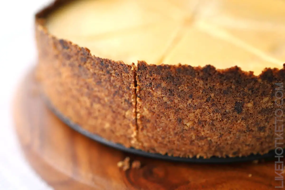 The side of a tall keto cheesecake made with the honey Graham cracker crust.