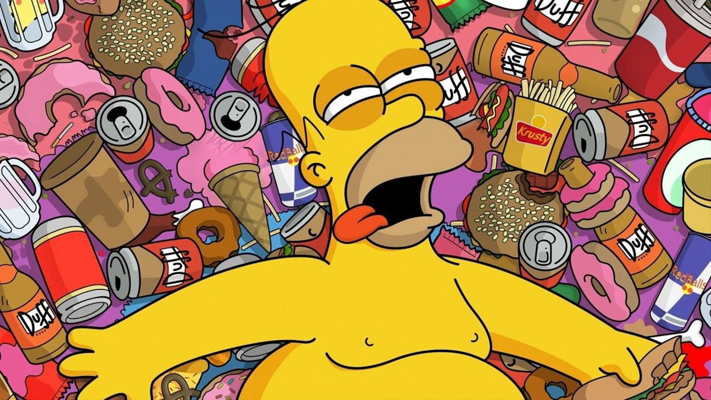 Homer Simpson, laying on a pile of high carb food and beer.