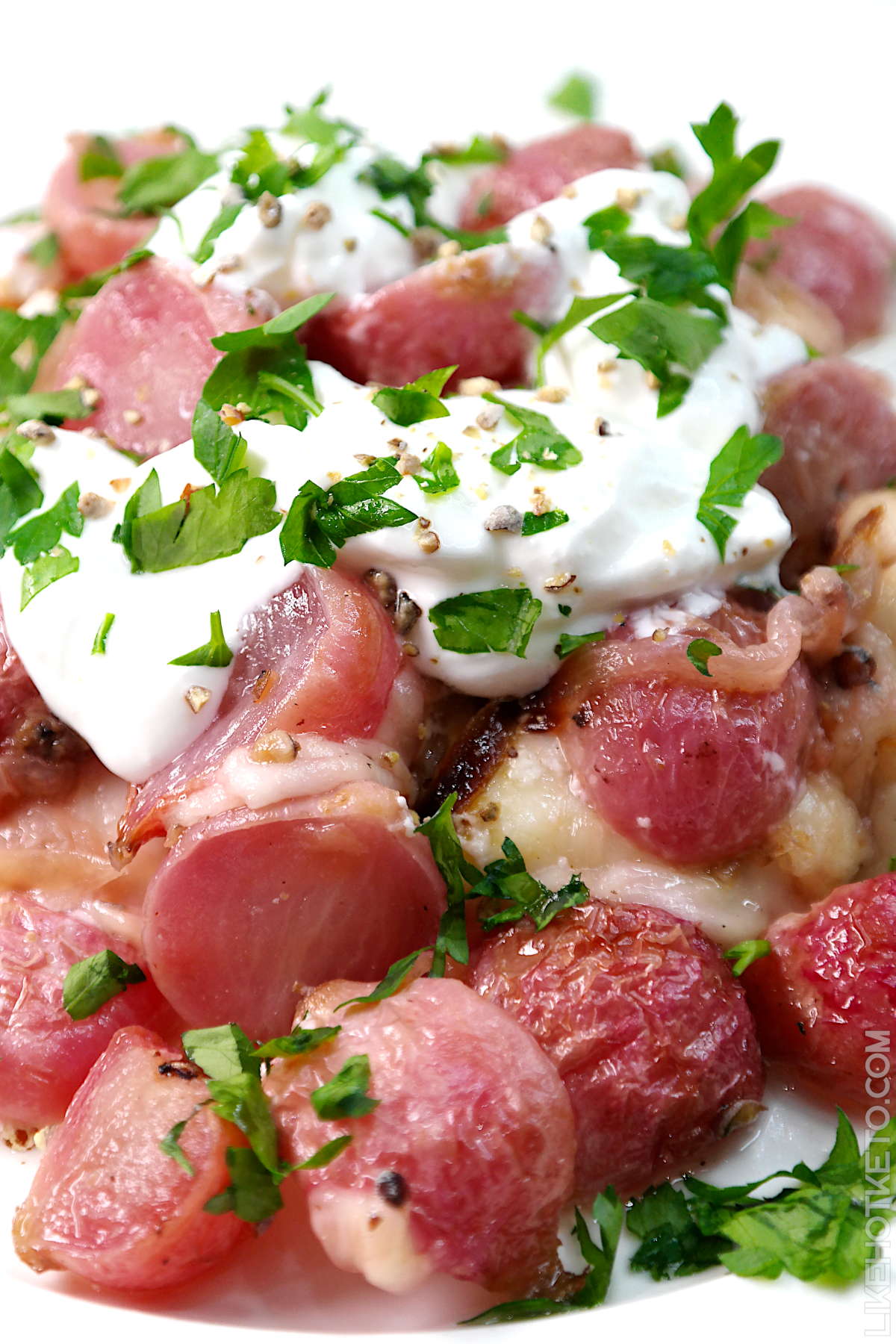 Radishes roasted in duck fat and topped with sour cream as a keto side dish.