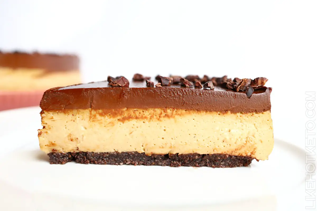 Side view of a slice of keto mocha no-bake cheesecake, with three layers