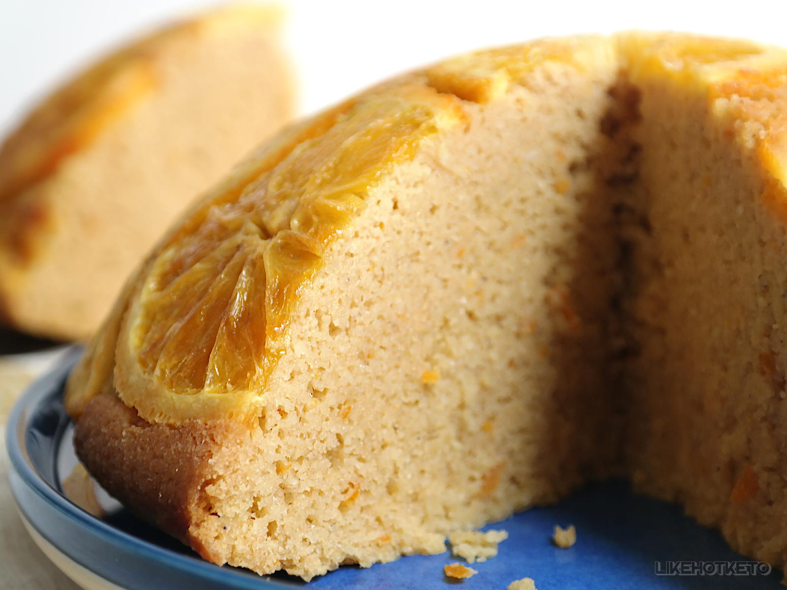 A sliced olive oil and orange sugar-free cake, showing its tender, fluffy cake crumb.