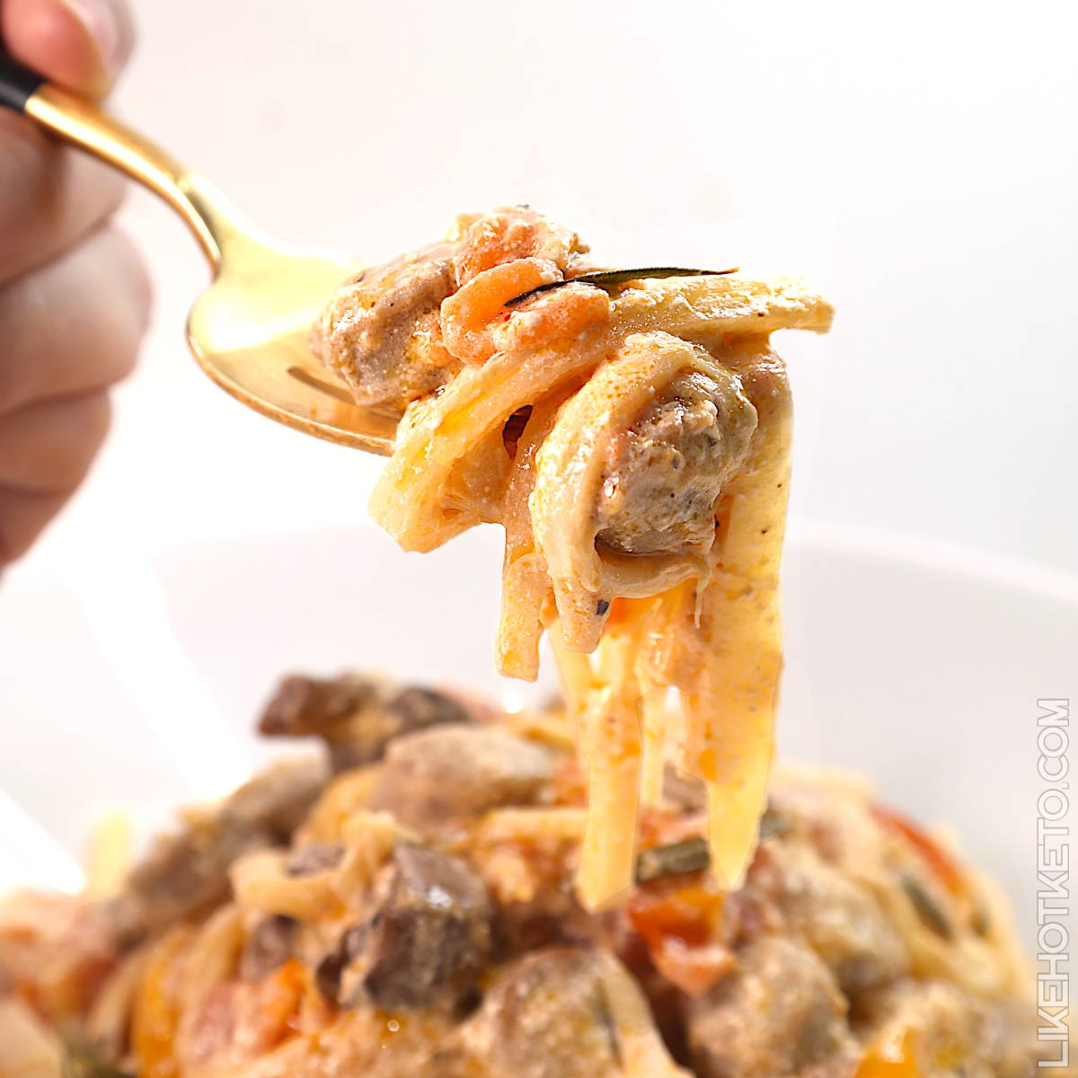 Keto baked feta Palmini pasta twirled around a fork.