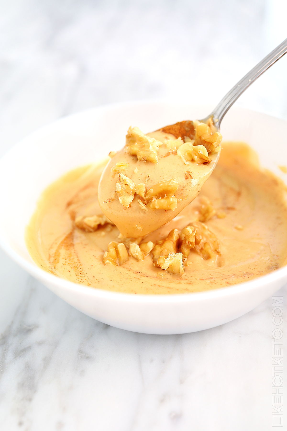 Spoon of keto Greek yogurt and peanut butter protein bowl.