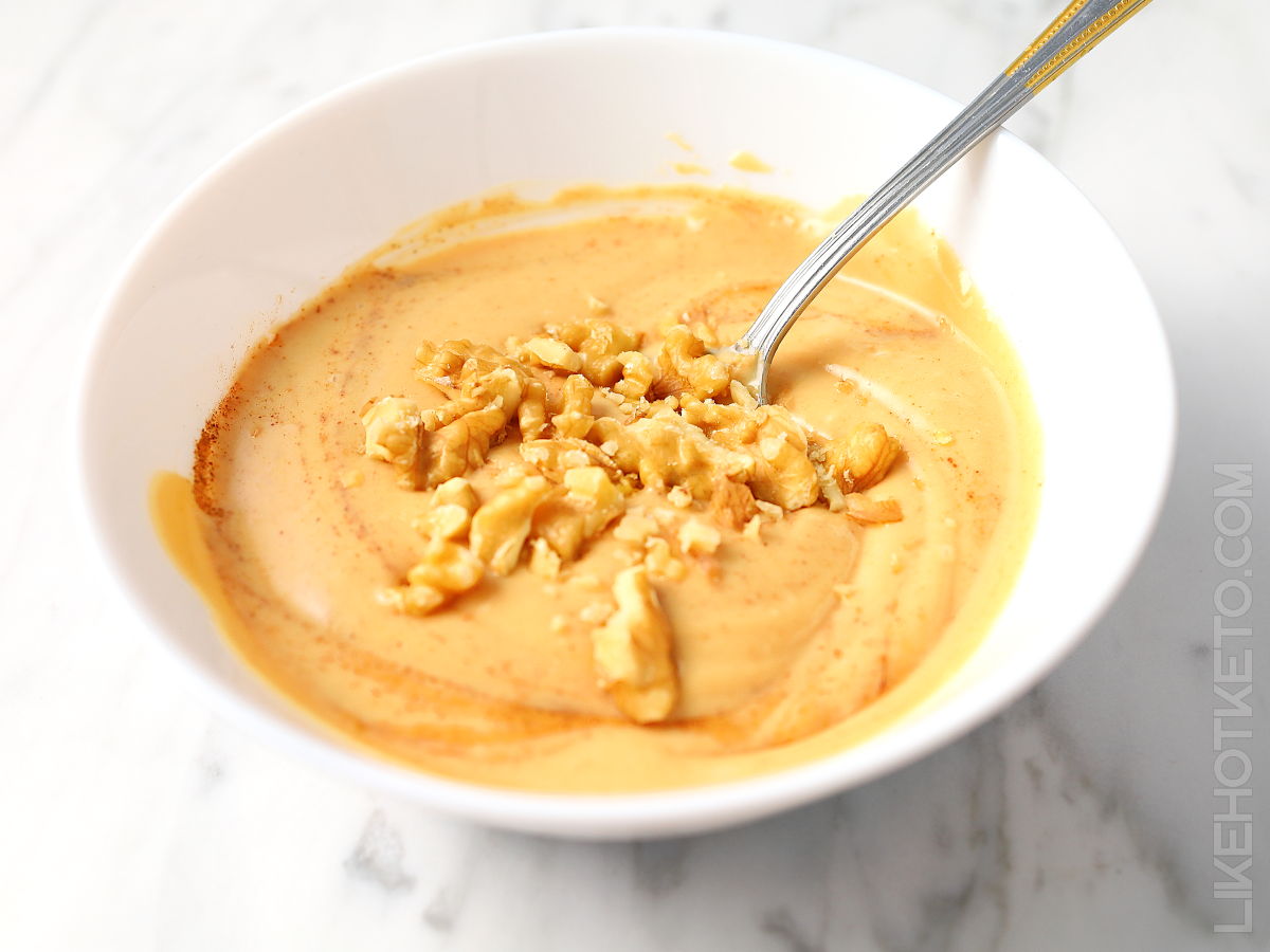 A bowl of high protein keto creamy yogurt with peanut butter.