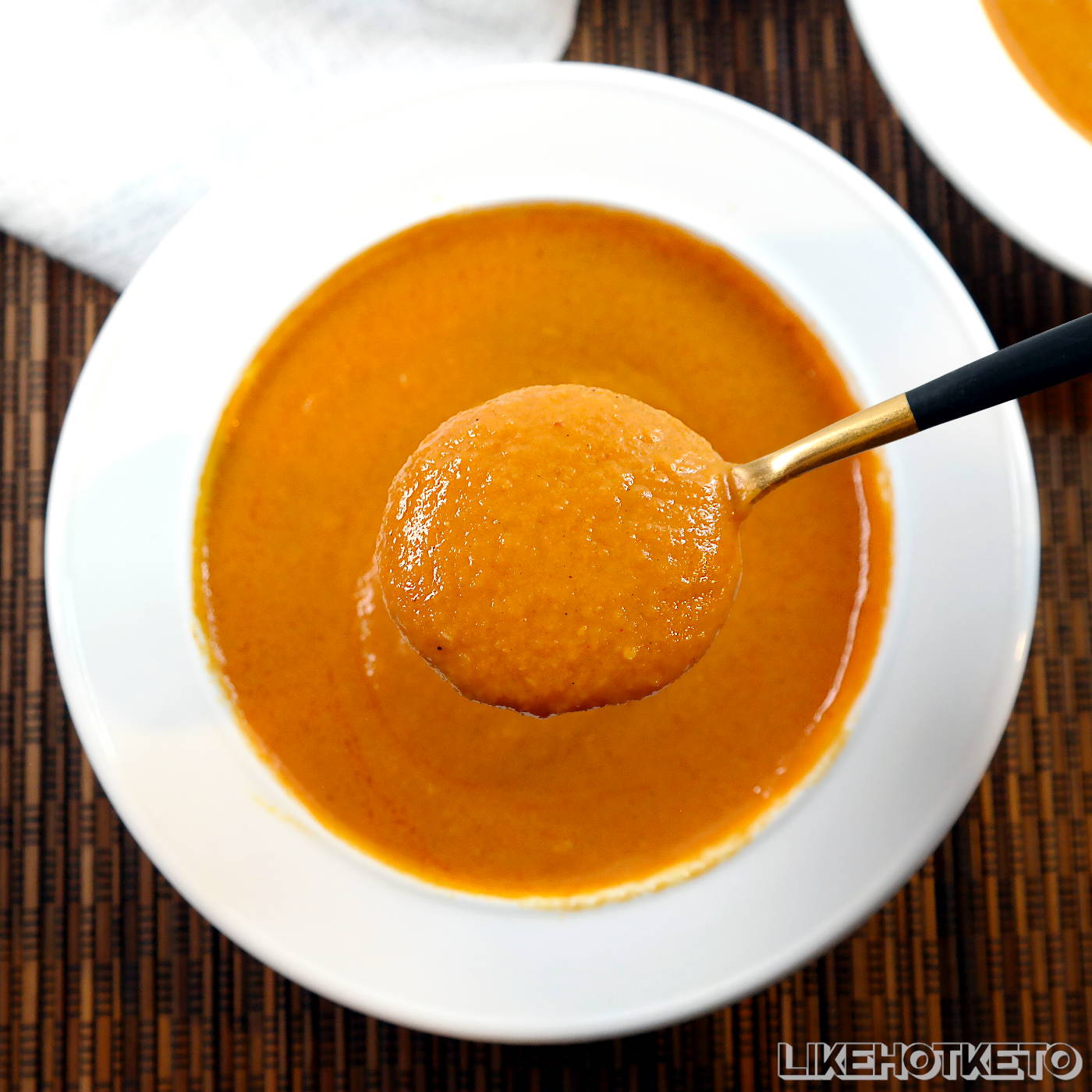A spoonful of keto cream of pumpkin and coconut soup.