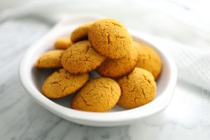 Pumpkin protein cookies in a white bowl.