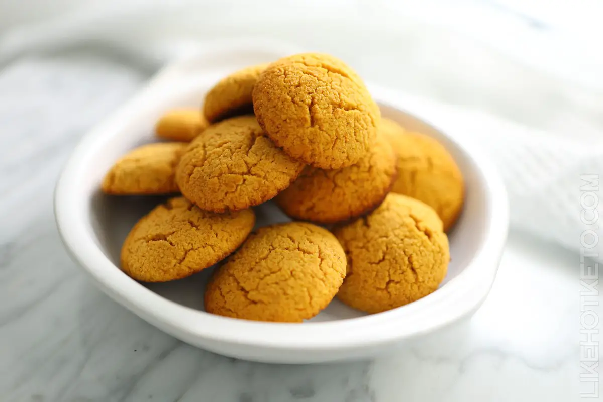 A pile of soft pumpkin keto cookies in a white bowl.