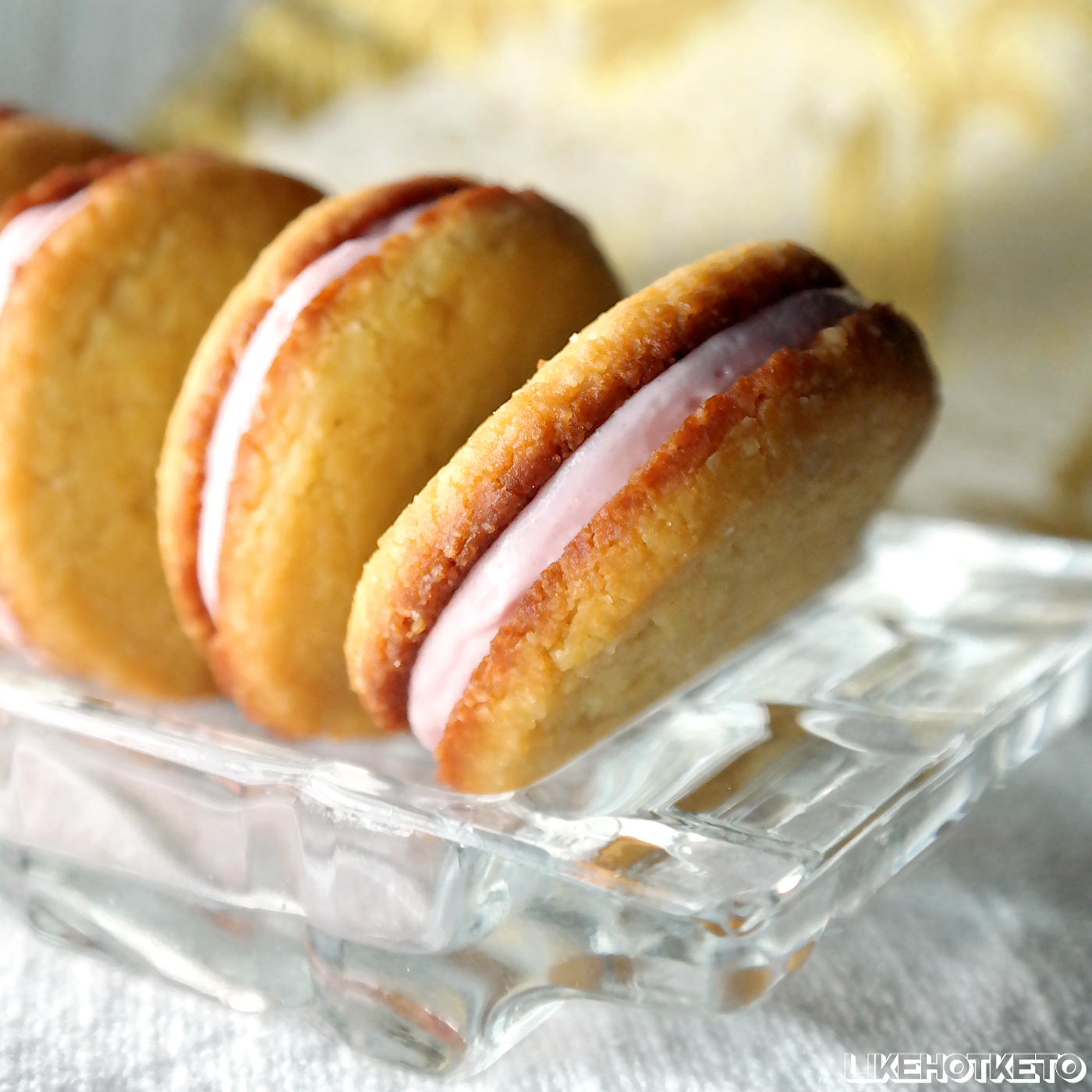 Golden vanilla sandwich cookies filled with a delicate pink sugar-free strawberry cream.