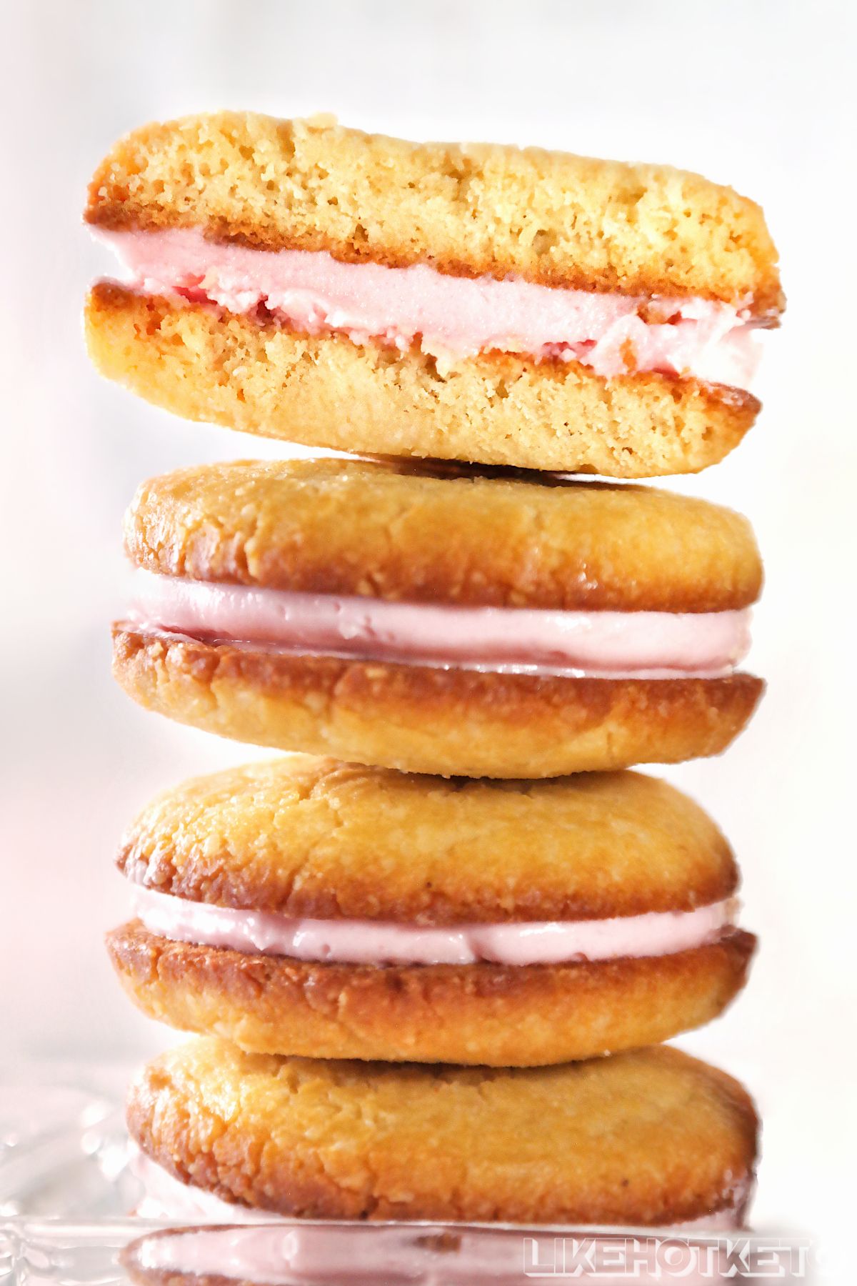 A pile of keto sugar-free sandwich cookies filled with strawberry cream.
