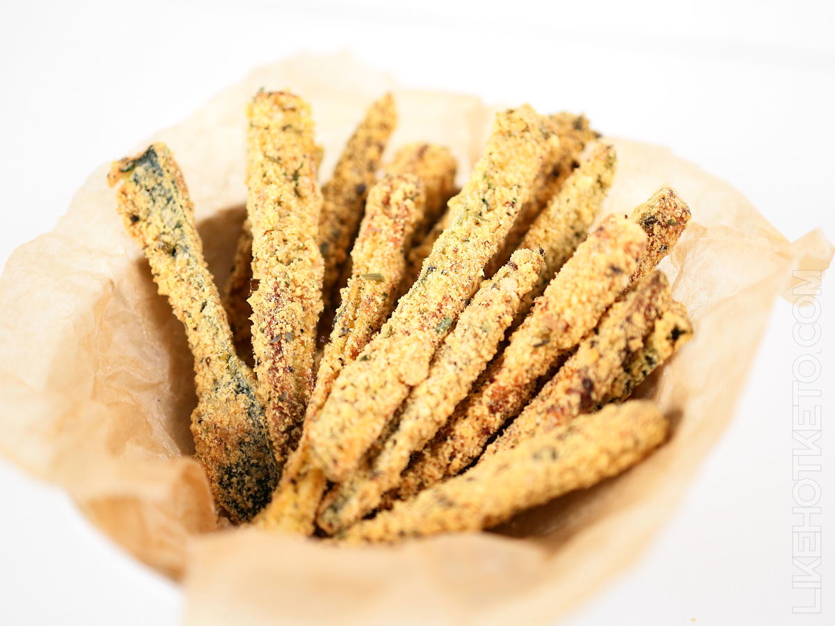 Golden zucchini fries served in a basket lined with parchment.