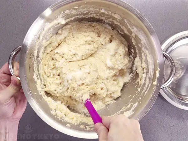 Folding chicken flour into beaten egg whites.
