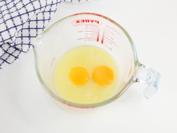 Melted butter and two eggs in a bowl.