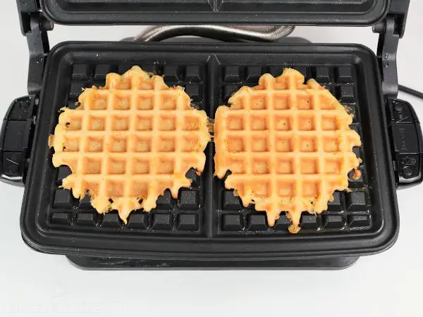 Chicken waffles fully cooked and ready in the waffle machine.