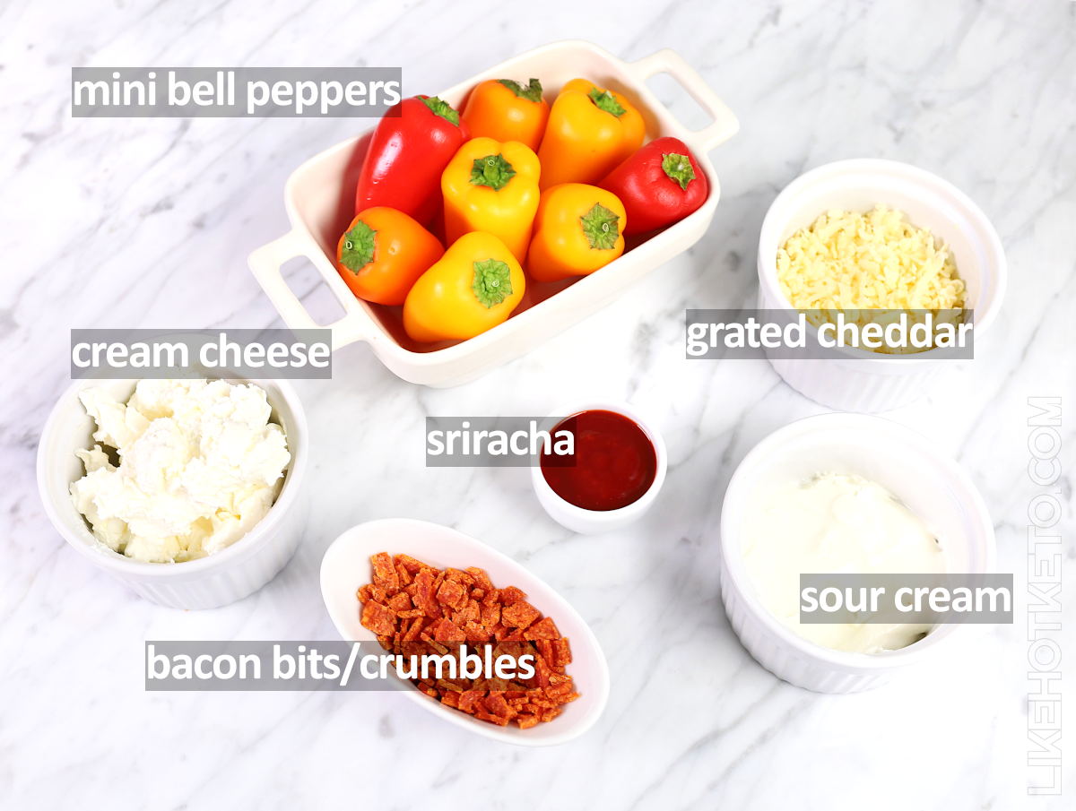 Labeled ingredients for stuffed mini peppers:  colorful peppers, grated cheddar, bacon bits, cream cheese, sour cream and sriracha.