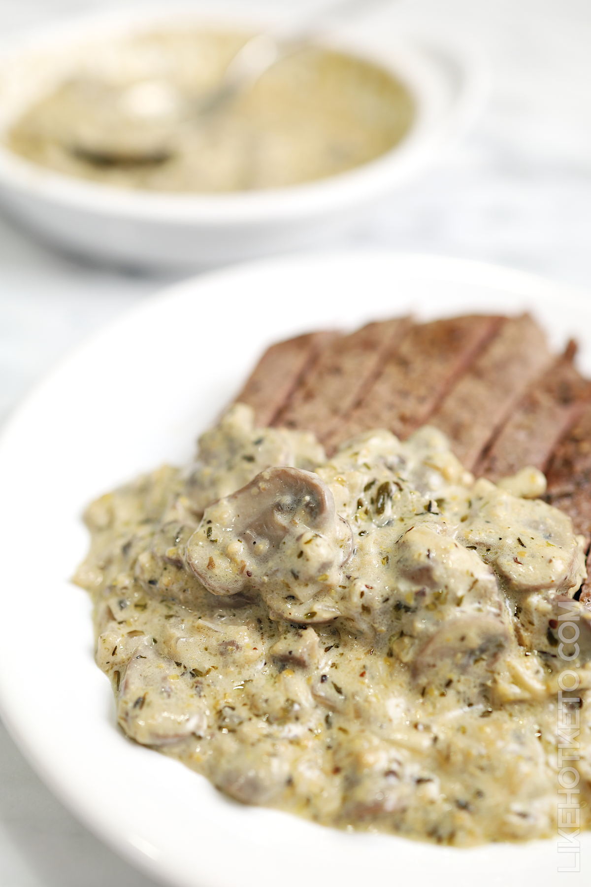 Steak strips covered with creamy keto mushroom sauce with garlic and butter.