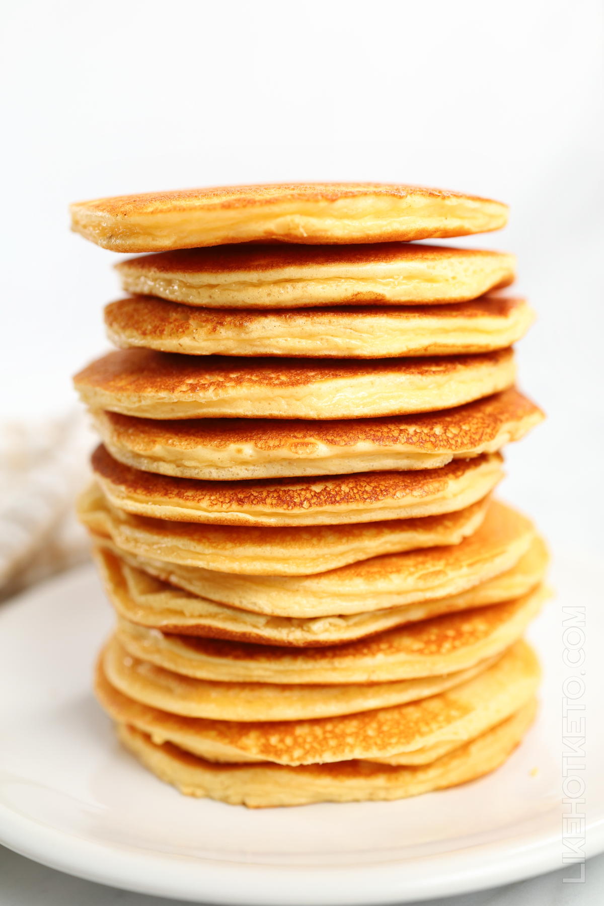 A very tall stack of golden keto protein pancakes.