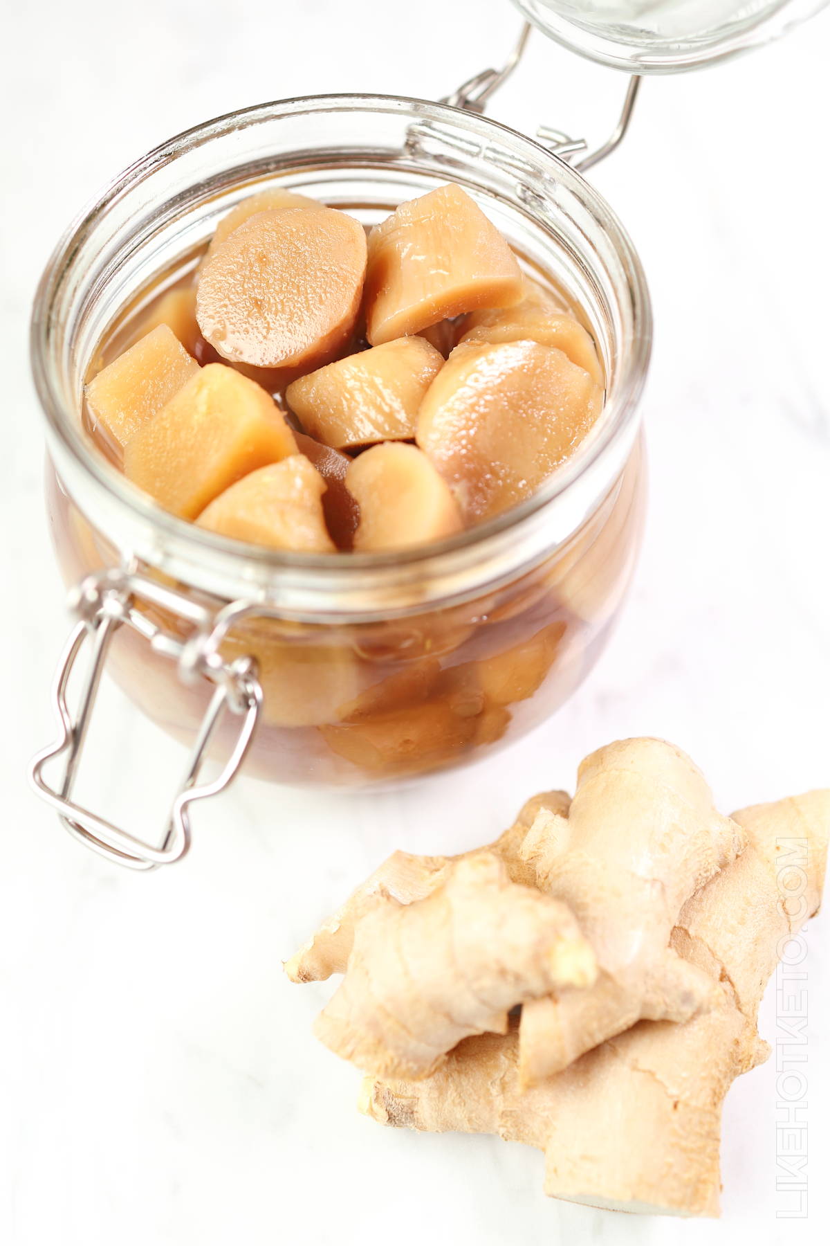 Homemade keto stem ginger in mason jar, fresh ginger knobs.