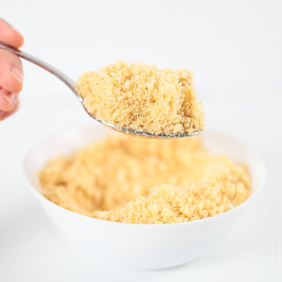 A tablespoon with freshly made keto pork rinds panko.