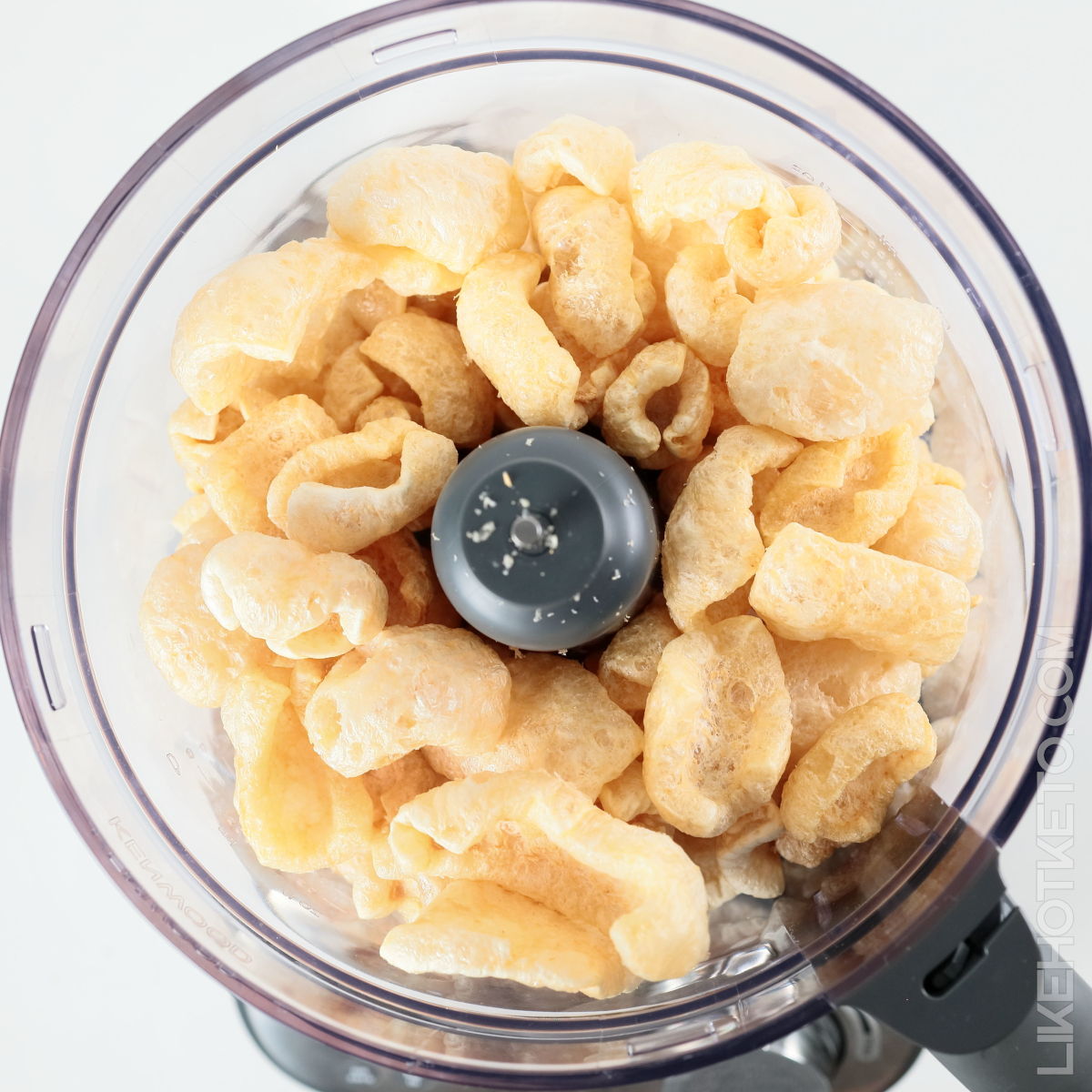 A food processor filled with pork rinds.