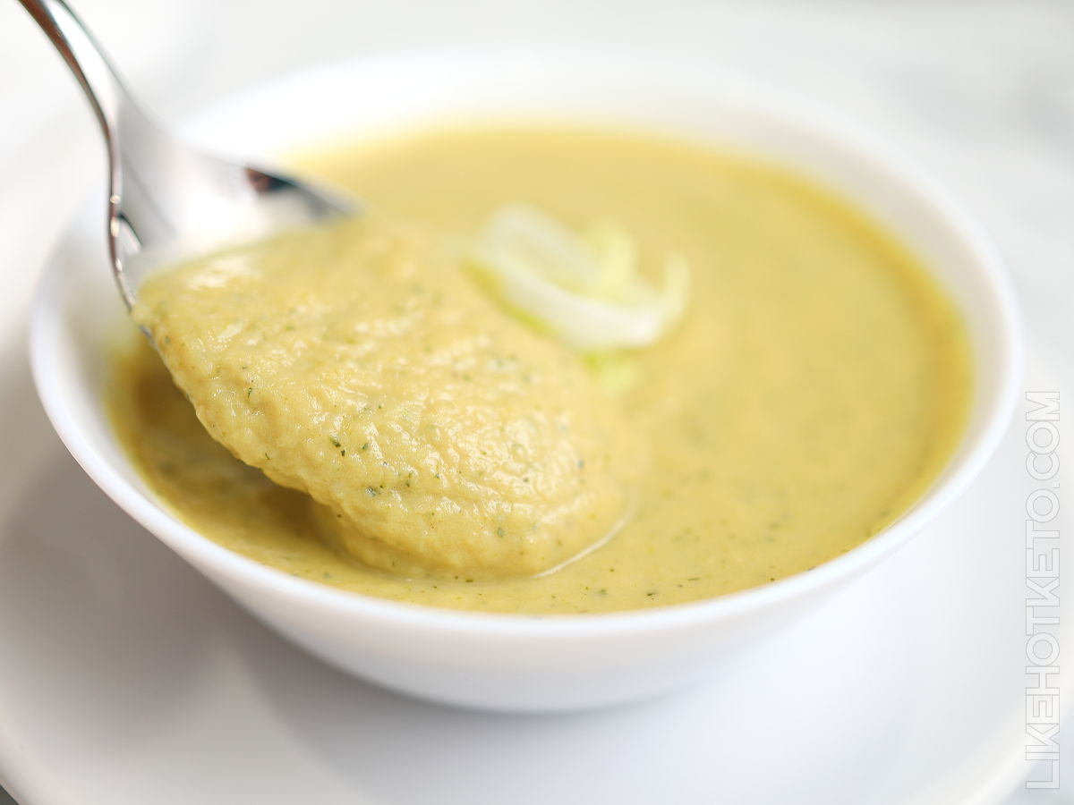 Spoon full of creamy leek and zucchini pea protein soup.