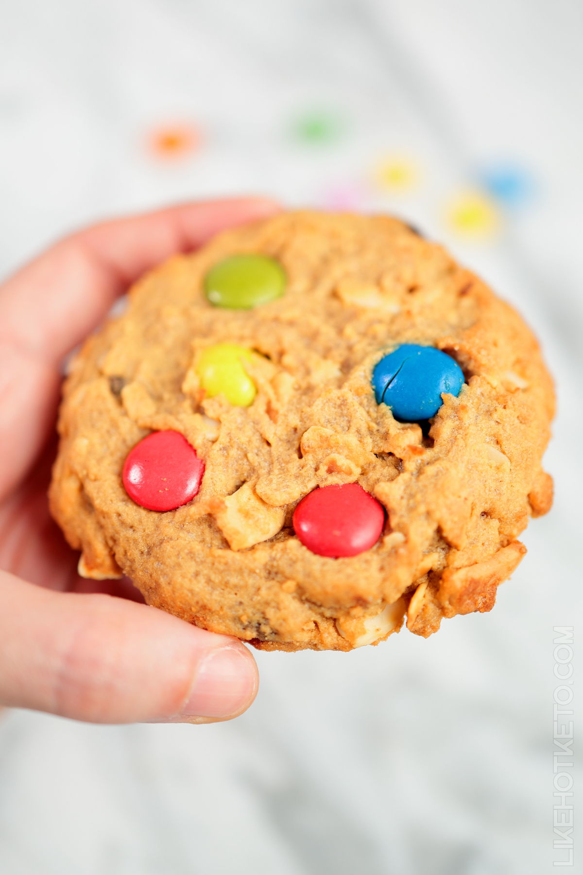 A large keto monster cookie with colorful m&m's.
