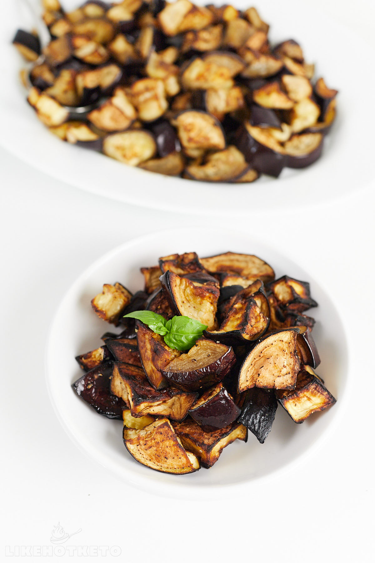 A serving of roasted eggplants on a small dish.