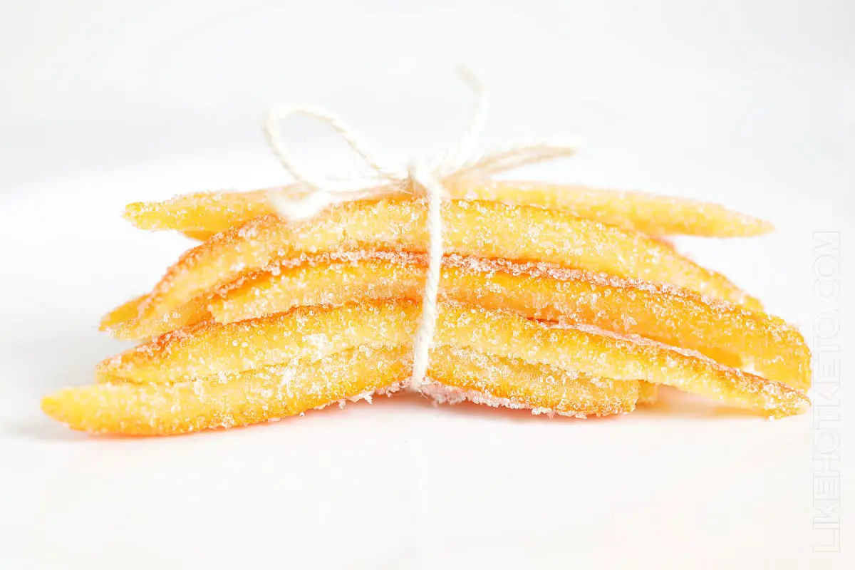 A bundle of thick and soft candied orange peels crusted with granulated sweetener, prettily tied up with string.
