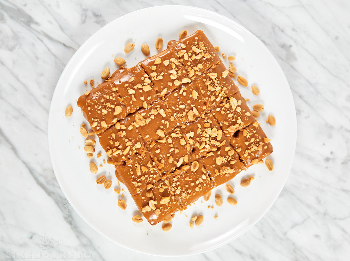 Peanut butter blondies topped with peanut butter and toasted crushed peanuts.