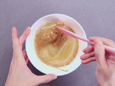 Mixing melted butter and peanut butter.