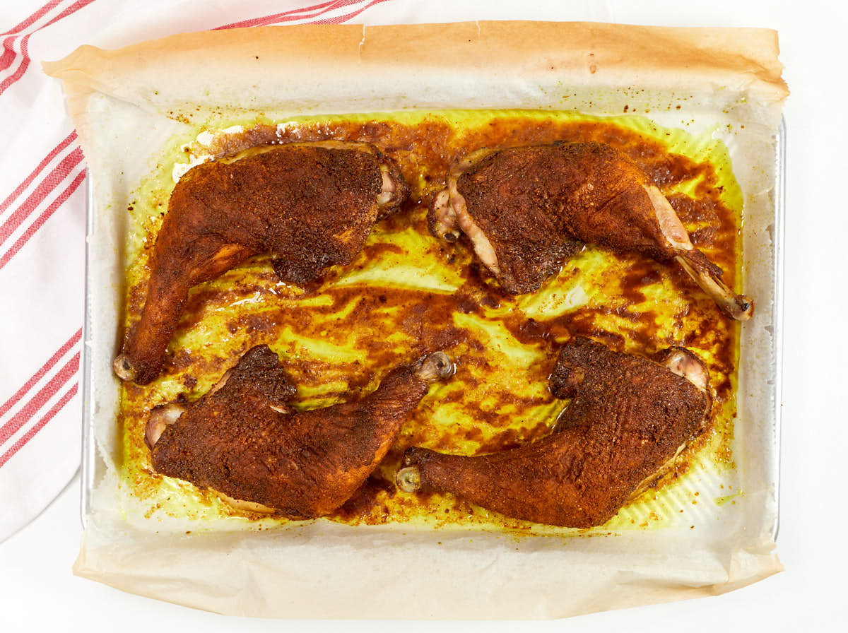 Ras el hanout chicken ready in roasting pan.
